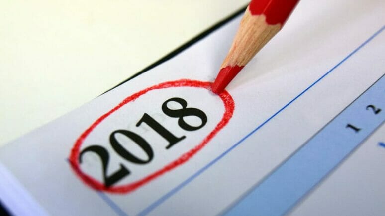 2018-16-9 Red pencil sitting on a calendar with the year 2018 circled in red