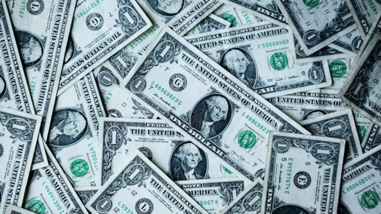salaryhistory_ban-16-9 one dollar bills scattered on top of each other