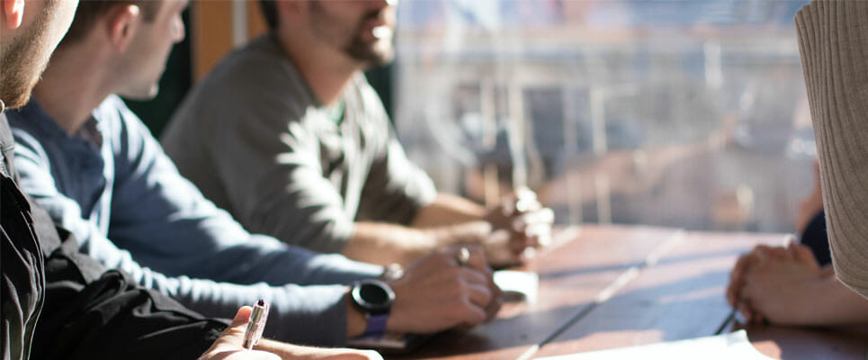 background-check-program group at a table talking