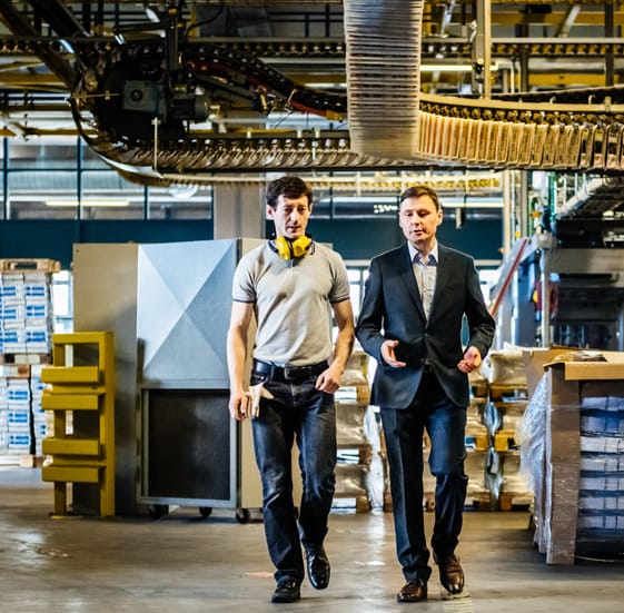 Two men walking in a warehouse